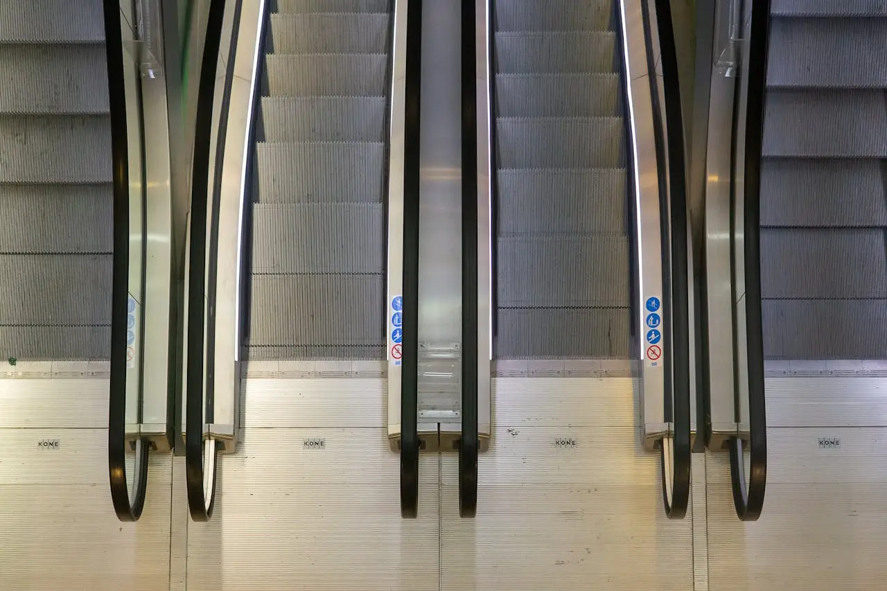 Aerial perspective of escalators in a Rotterdam building, showcasing industrial design and symmetry.