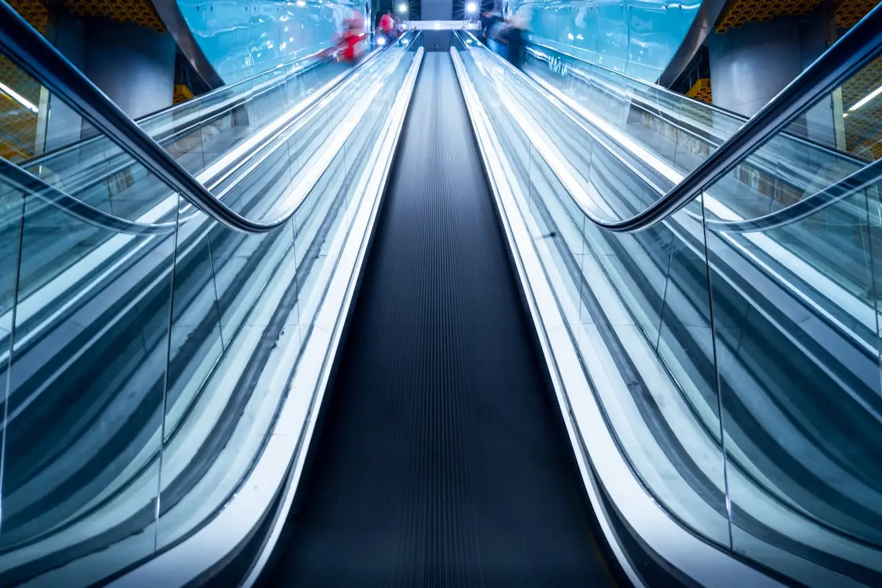 Dynamic low angle shot of a modern escalator with glass panels in Warsaw, Poland.